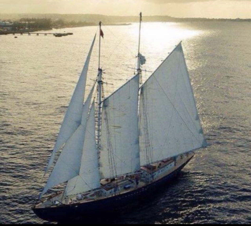 The schooner Ruth under full sail in golden evening light off the Barbados coast